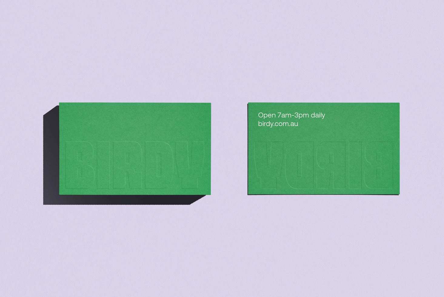 Business card mockup with blind embossing effect on green cardstock, showcasing font and design layout. Perfect for branding, presentations, and templates.